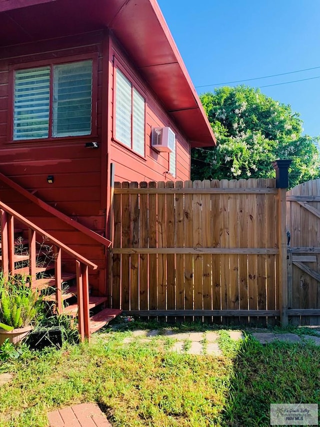 view of home's exterior with a wall mounted air conditioner