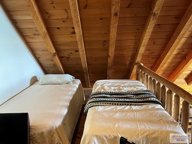 bedroom featuring beamed ceiling and wooden ceiling