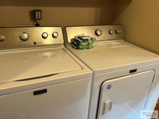 clothes washing area with washing machine and dryer