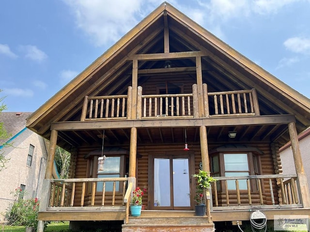 back of house featuring a balcony