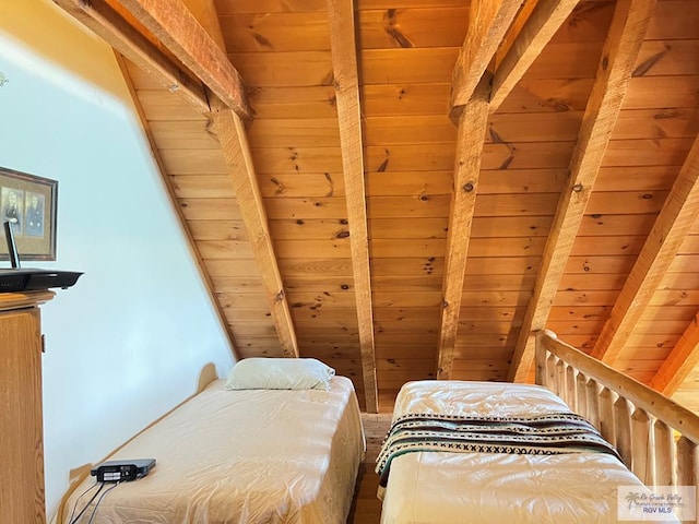 bedroom with beamed ceiling and wooden ceiling