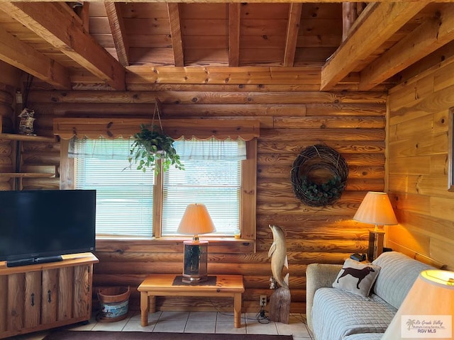 sitting room with log walls, beamed ceiling, light tile patterned floors, and wood ceiling