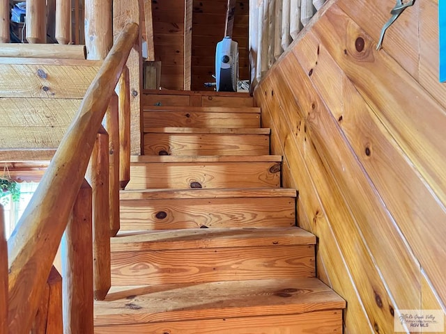 staircase with wood walls