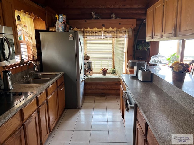 kitchen featuring sink, light tile patterned floors, and stainless steel appliances