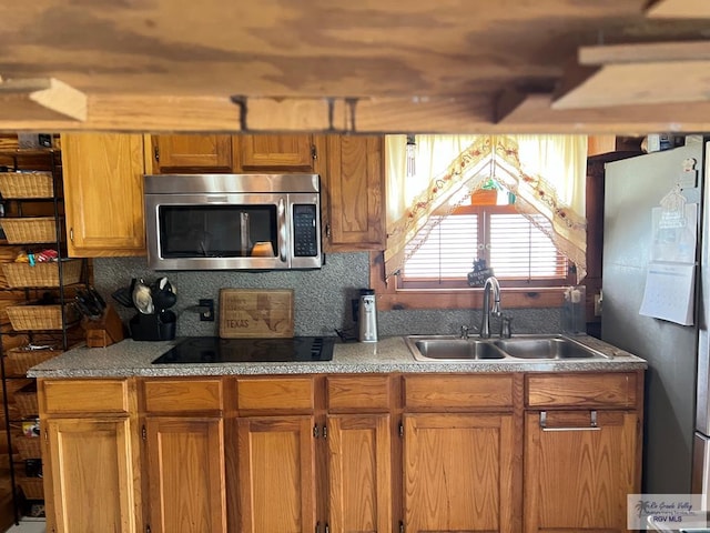 kitchen with stainless steel appliances, tasteful backsplash, and sink