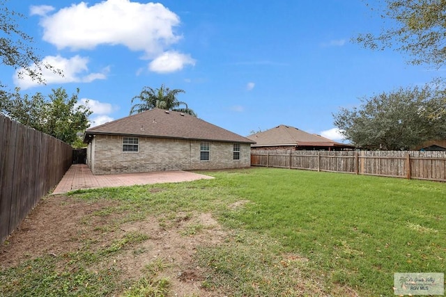 back of property with a patio and a lawn