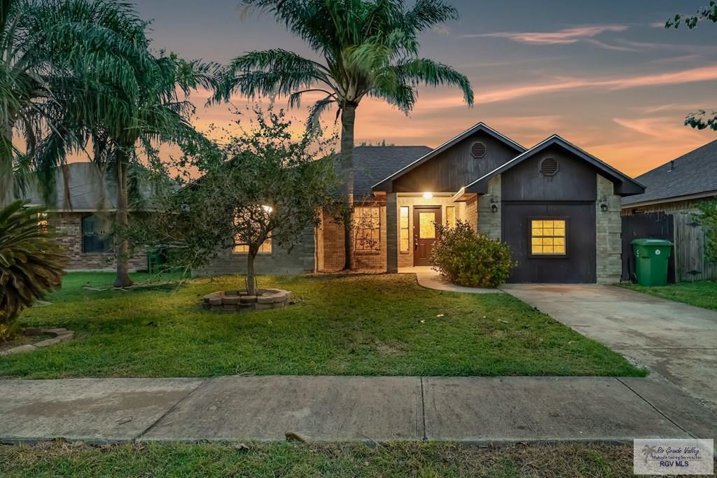 1057 Hope Dr, Brownsville, TX 78520 - view of front facade featuring a yard