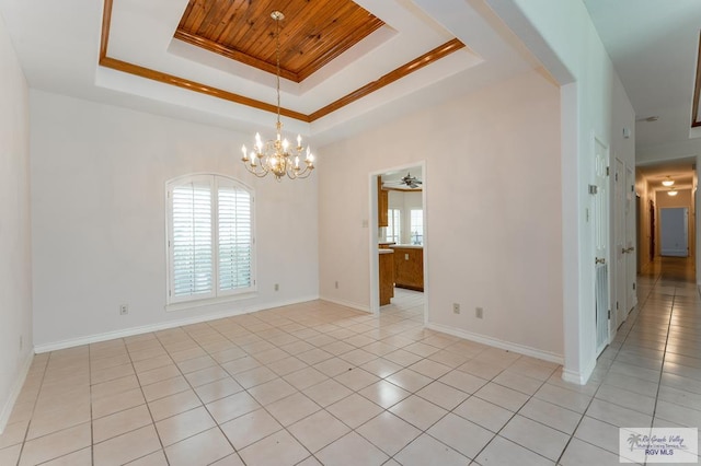 tiled empty room with ceiling fan with notable chandelier, a raised ceiling, crown molding, and wood ceiling