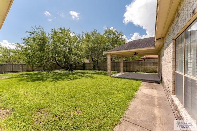 view of yard featuring a patio and ceiling fan