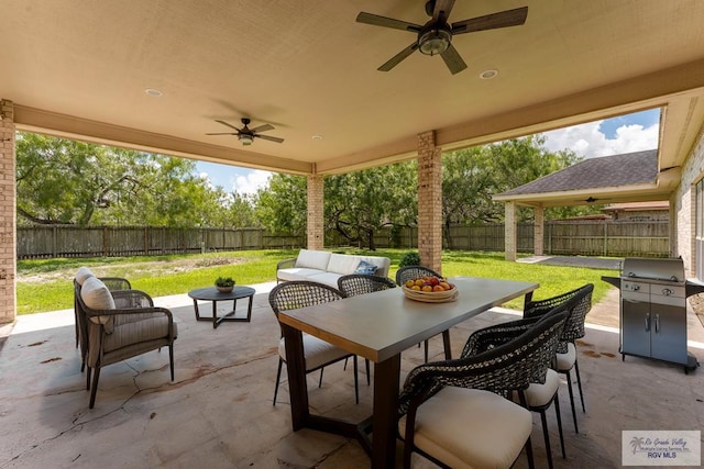 view of patio / terrace with an outdoor living space, area for grilling, and ceiling fan