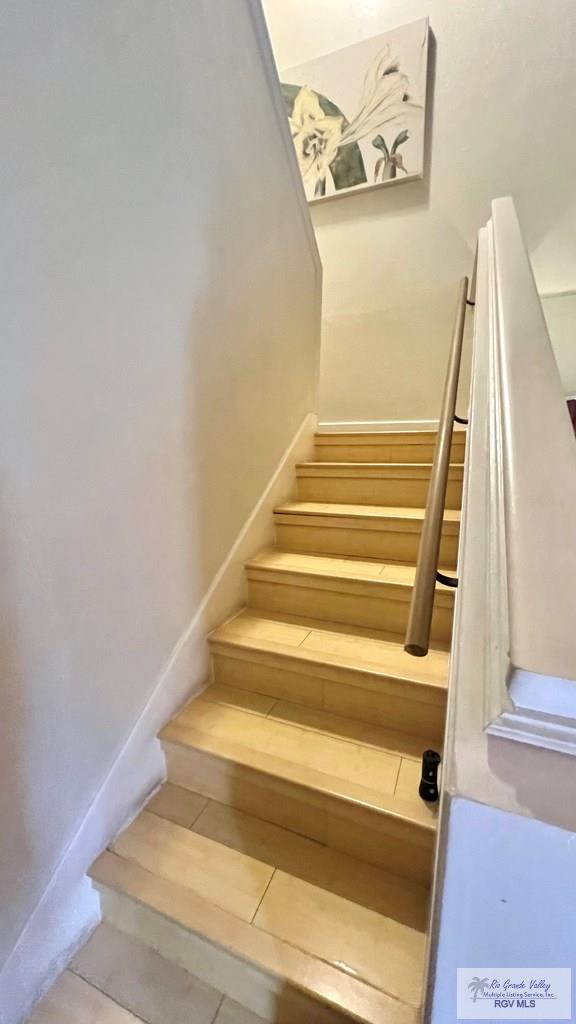 staircase with tile patterned floors