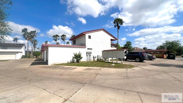 view of side of property featuring stucco siding