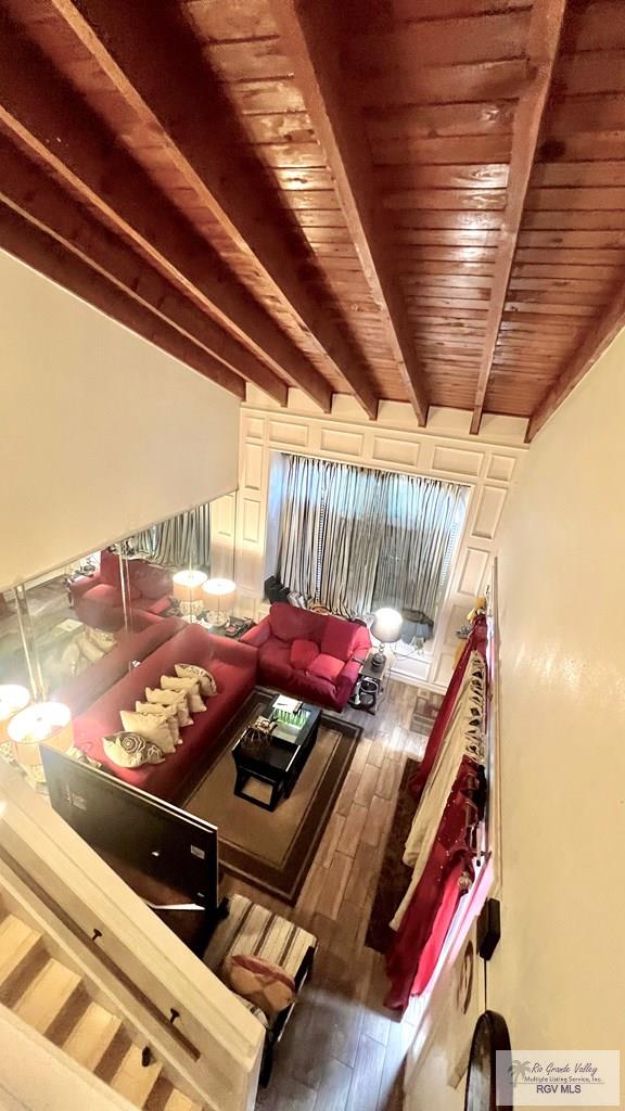 living area with beamed ceiling, wood ceiling, and hardwood / wood-style flooring