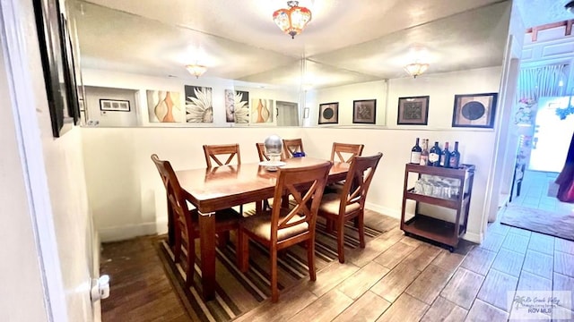 dining room featuring baseboards and wood tiled floor