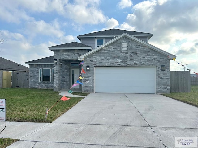 view of front of house featuring a front lawn, fence, concrete driveway, a garage, and brick siding