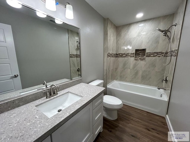 full bath featuring vanity, toilet, shower / bath combination, and wood finished floors