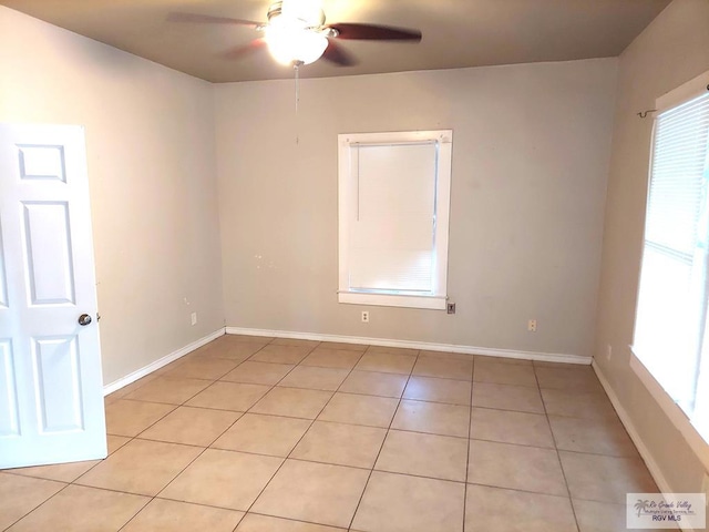 unfurnished room with ceiling fan, plenty of natural light, and light tile patterned flooring