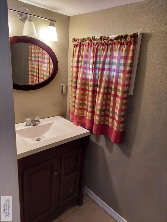 bathroom featuring tile patterned flooring and vanity