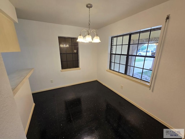 unfurnished dining area featuring a notable chandelier