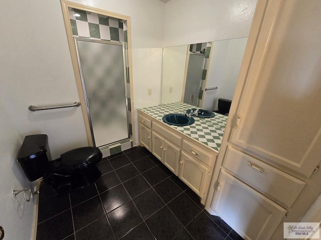 bathroom with walk in shower, tile patterned floors, and vanity