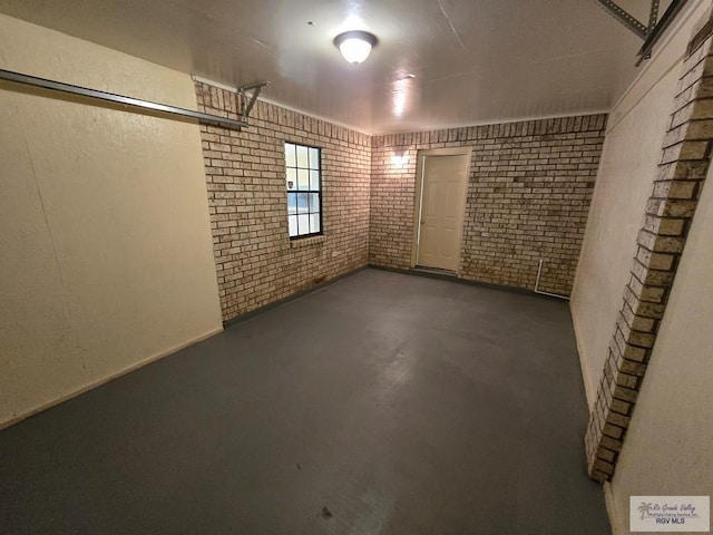 basement featuring brick wall