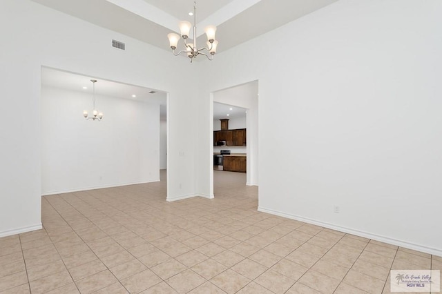 unfurnished room with a chandelier and light tile patterned floors