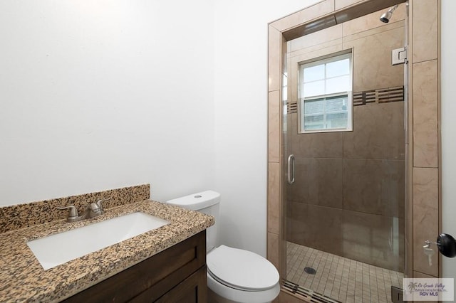 bathroom with vanity, toilet, and walk in shower