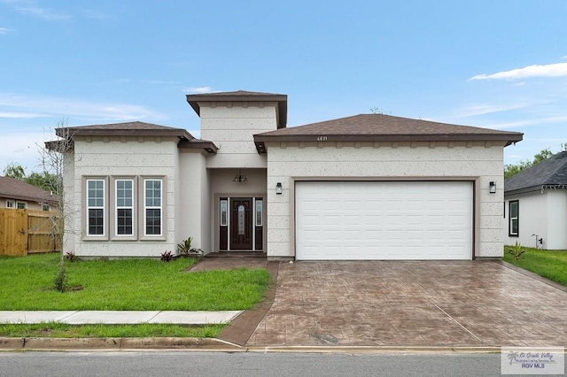 view of front facade featuring a garage and a front yard