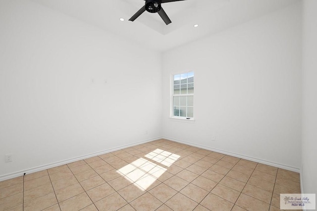 tiled spare room with ceiling fan