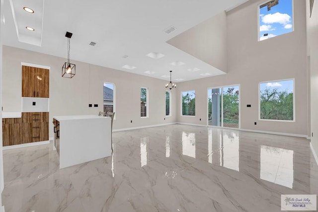 unfurnished living room with a notable chandelier