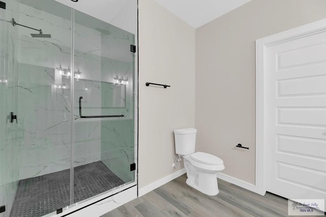 bathroom featuring toilet, an enclosed shower, and hardwood / wood-style flooring