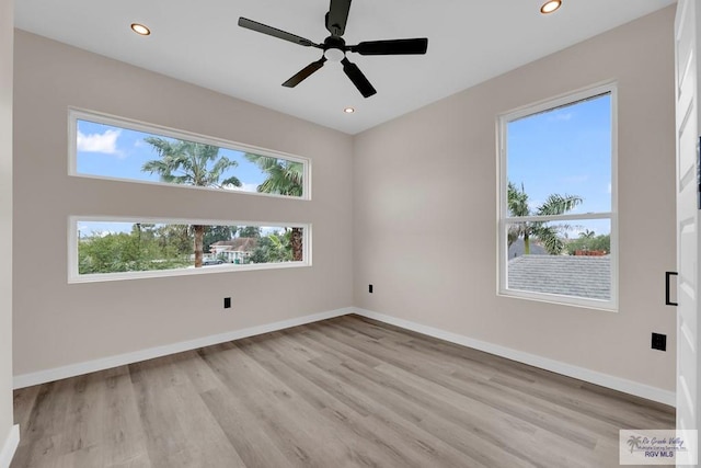 spare room with a wealth of natural light and light hardwood / wood-style flooring