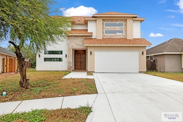 view of front of home featuring a garage and a front lawn