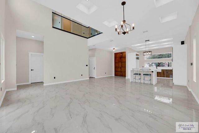 unfurnished living room with a notable chandelier