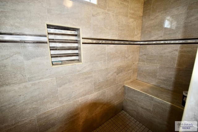 bathroom with tiled shower