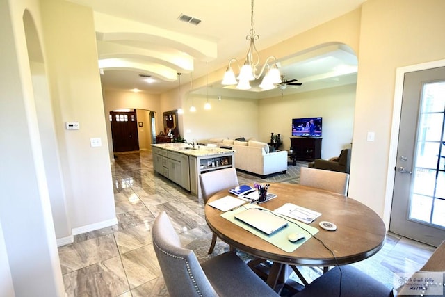 dining area with a wealth of natural light and an inviting chandelier