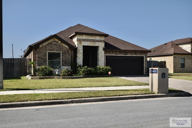 view of front of house with a garage and a front yard