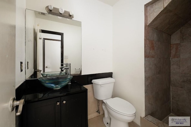 bathroom with tile patterned flooring, vanity, and toilet