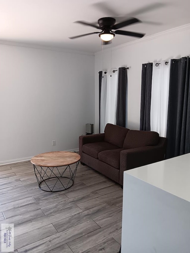 living room with ceiling fan, light hardwood / wood-style floors, and ornamental molding