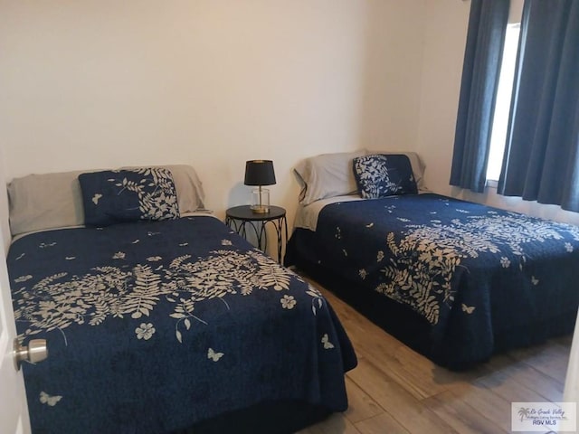 126 E Esperanza St Unit 101, South Padre Island, TX 78597 - bedroom featuring wood finished floors