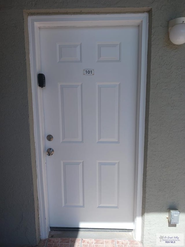 126 E Esperanza St Unit 101, South Padre Island, TX 78597 - doorway to property with stucco siding