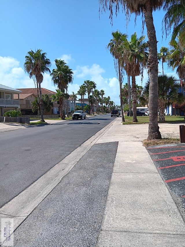 126 E Esperanza St Unit 101, South Padre Island, TX 78597 - view of asphalt street with sidewalks, a residential view, and curbs