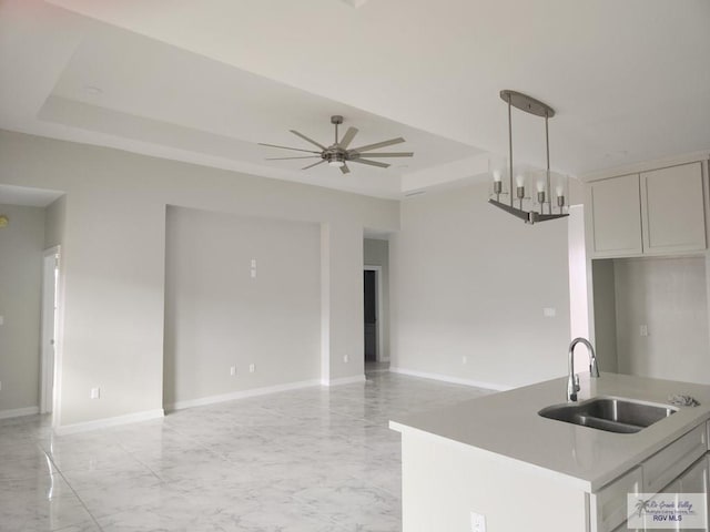4806 Holly Ann St, Harlingen, TX 78552 - kitchen featuring open floor plan, marble finish floor, a raised ceiling, and a sink