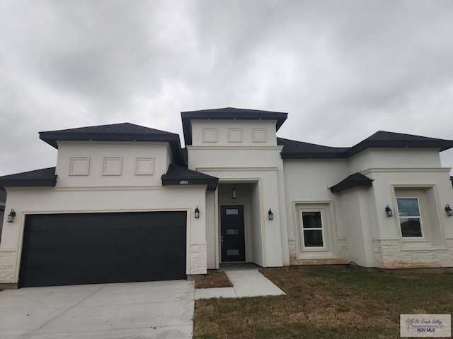 4806 Holly Ann St, Harlingen, TX 78552 - prairie-style home with concrete driveway, stone siding, and stucco siding