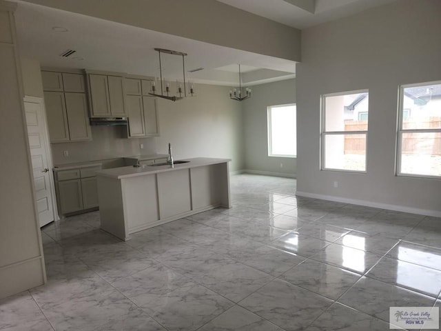 4806 Holly Ann St, Harlingen, TX 78552 - kitchen with marble finish floor, baseboards, a tray ceiling, and a sink