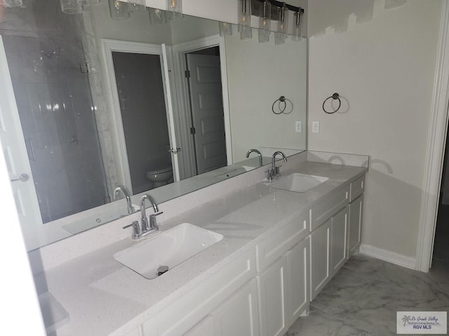 4806 Holly Ann St, Harlingen, TX 78552 - full bathroom featuring marble finish floor, toilet, and a sink