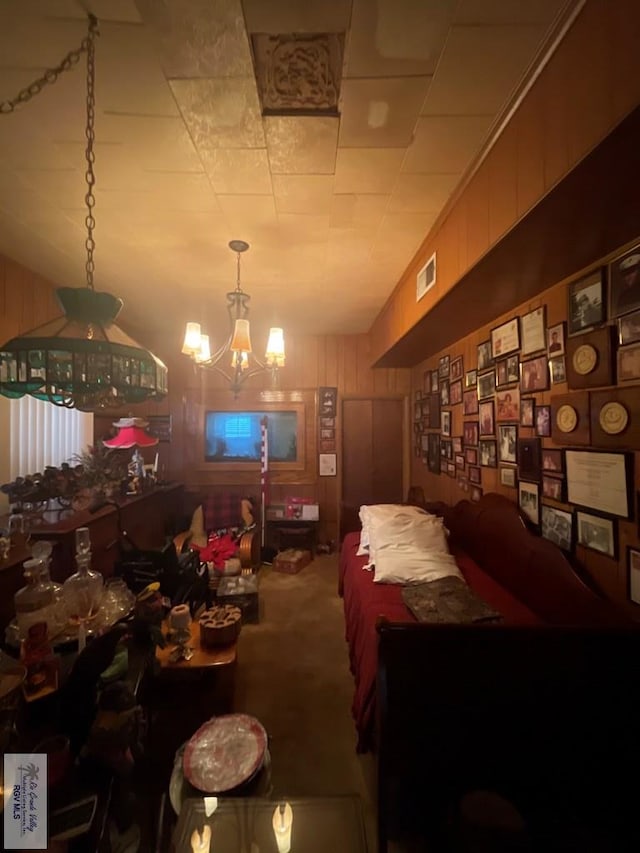 121 E Washington St, Brownsville, TX 78520 - living room with a chandelier, wooden walls, and carpet