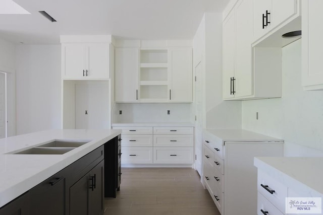 8830 Wentz Lk, Brownsville, TX 78520 - kitchen with light countertops, white cabinetry, open shelves, and dark cabinets
