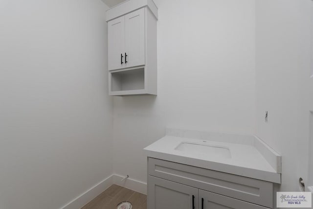 8830 Wentz Lk, Brownsville, TX 78520 - laundry area featuring baseboards and wood finished floors