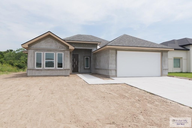 8830 Wentz Lk, Brownsville, TX 78520 - view of front of house with an attached garage, concrete driveway, and a shingled roof